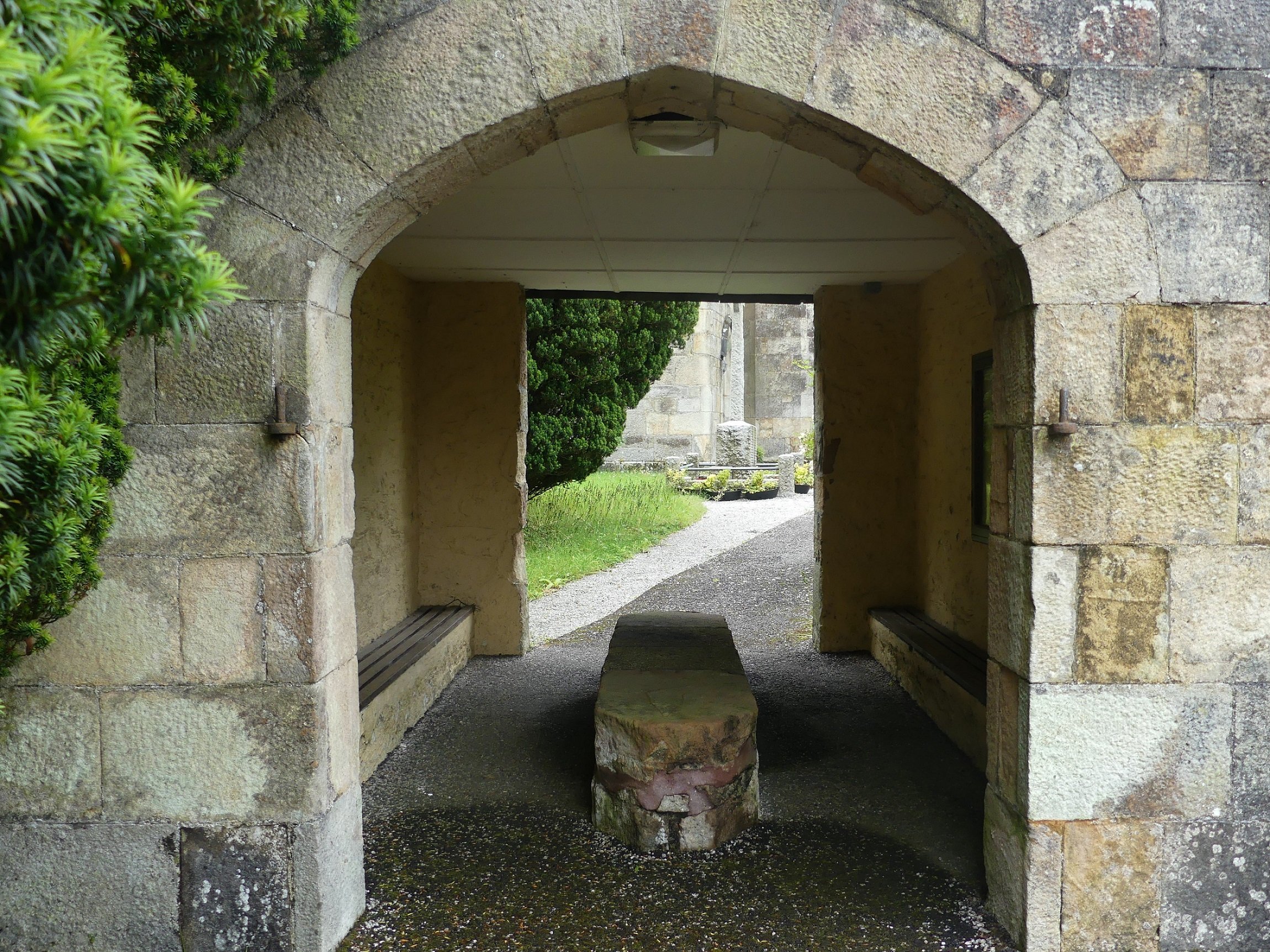 A stone archway with a stone slab for a coffin rest