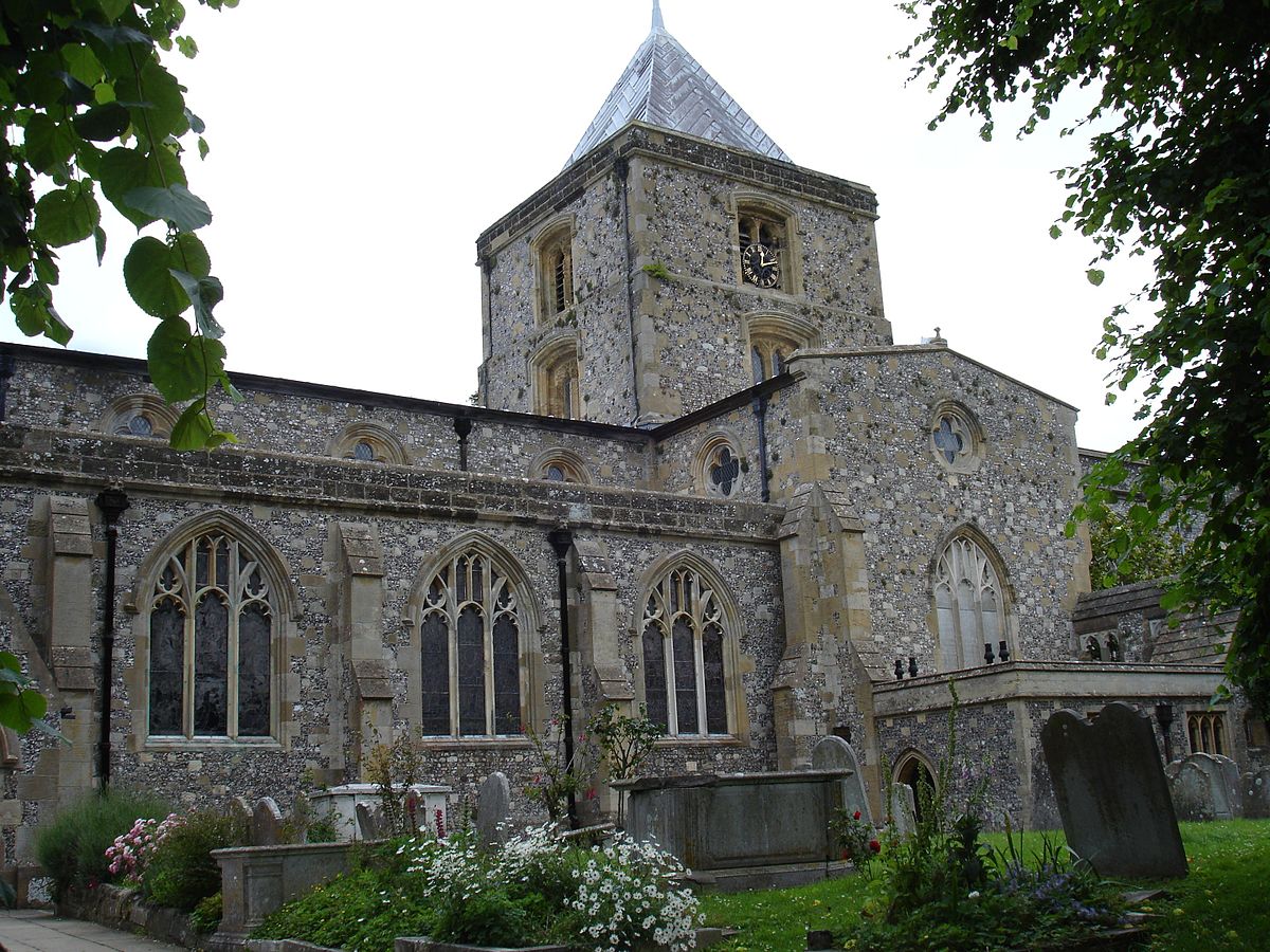 Flint exterior of church with tower and clock