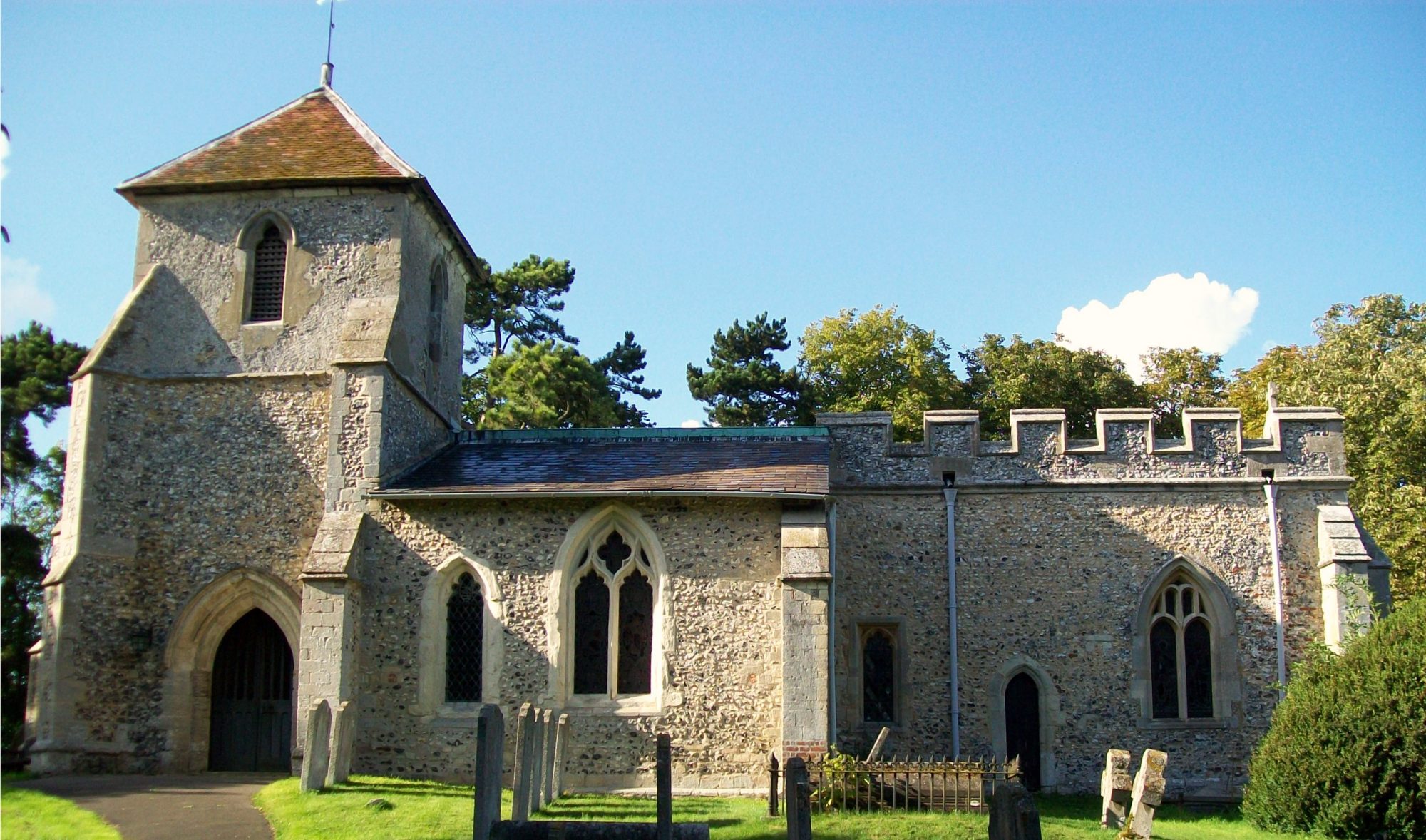 Stone church with battlements and low bell tower