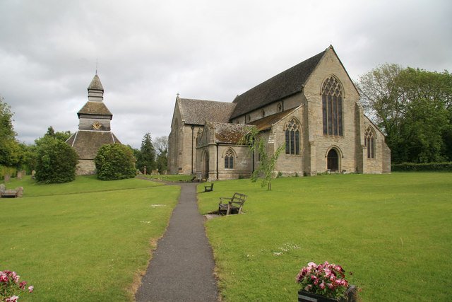 Large church surrounded by grass and with a separate octagonal belfy next to it