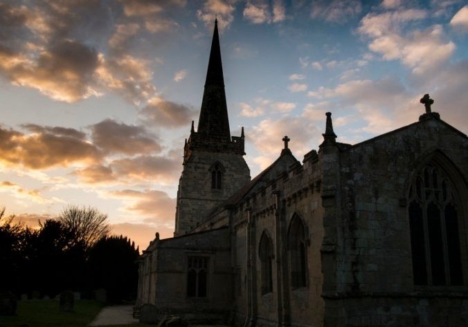 Church at dusk with dramatic sky behind steeple