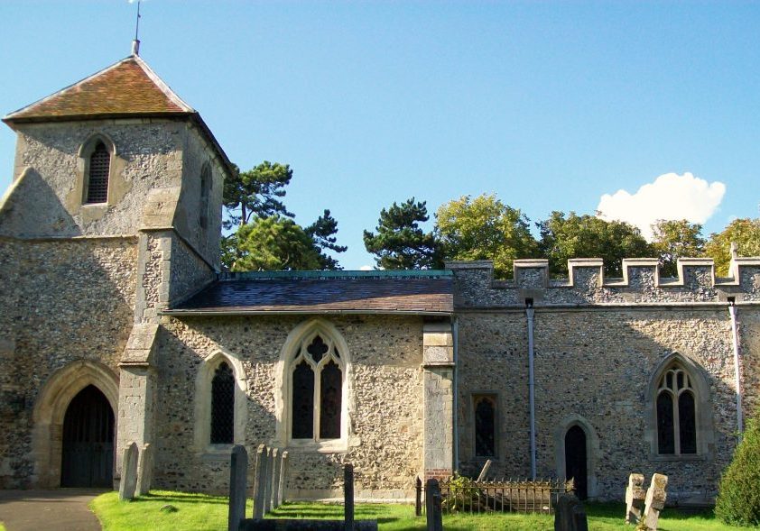 Stone church with battlements and low bell tower