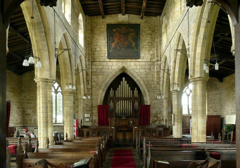 Inside church nave with Royal Arms above organ