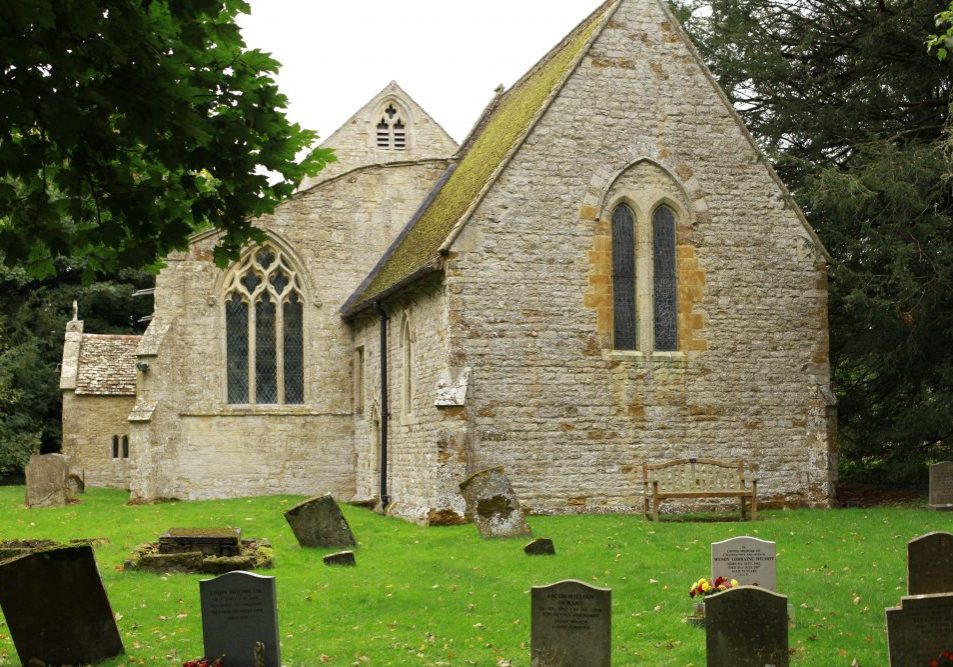 Stone church exterior from east with bench and gravestones