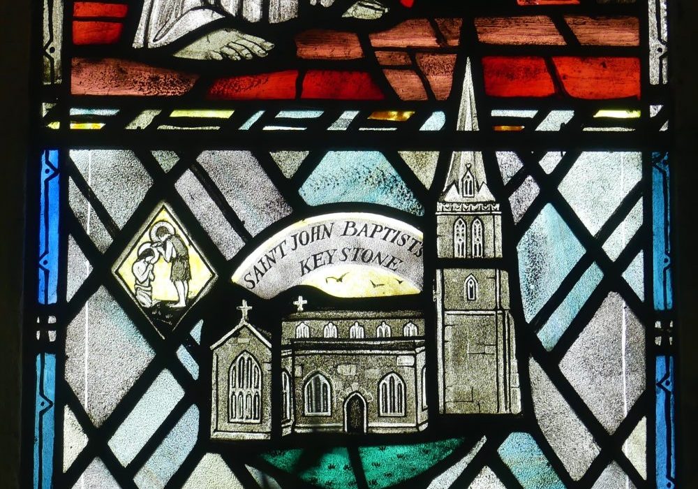 A stained glass image of St John The Baptist church