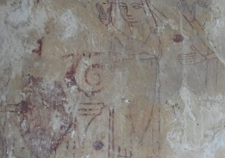 A medieval wall painting showing the red outline of a bishop wearing a yellow mitre
