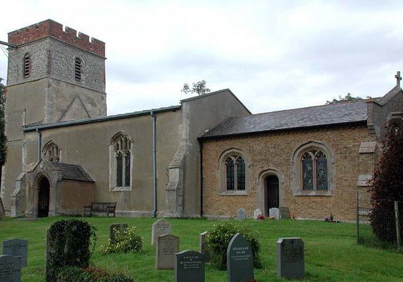 Stone medieval church with bell tower and 19th century brick chancel